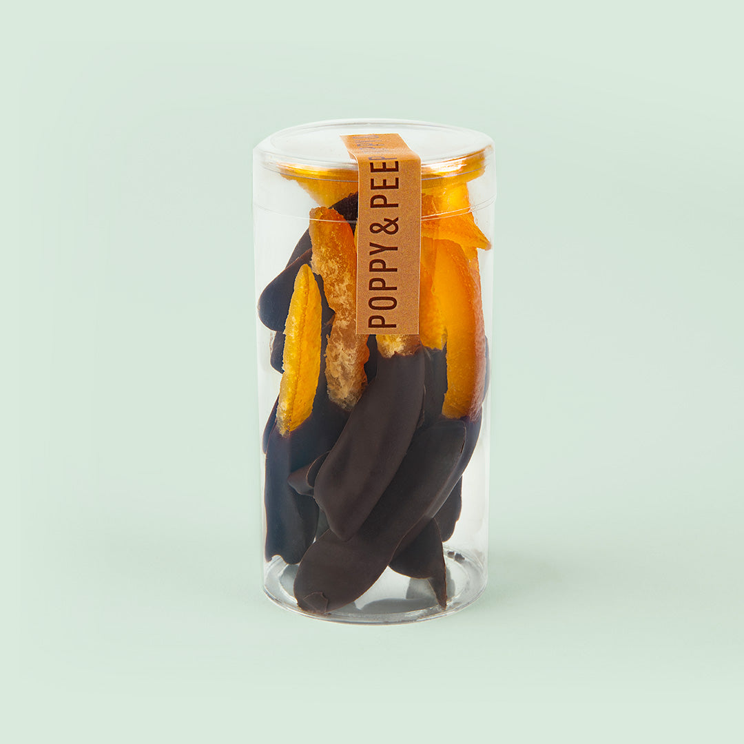 Candied orange peel strips dipped in dark chocolate in a clear Poppy & Peep tube